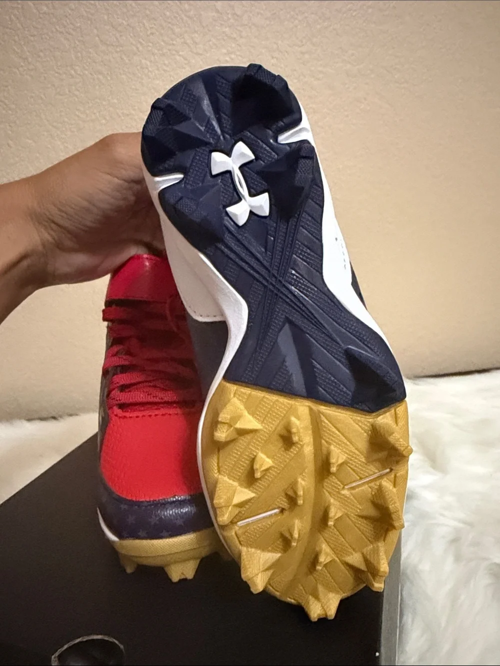 Under Armour Kids Red and Navy Football Cleats with Gold Accents